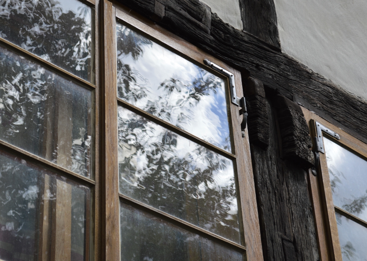 auswärtes öffnendes Kastenfenster mit Winkelbändern und Stützkloben sowie Fourcaultverglasung, stumpf im Fachwerk eingebaut