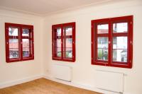 Rote Fenster aus Holz im Altbau mit Denkmalschutz