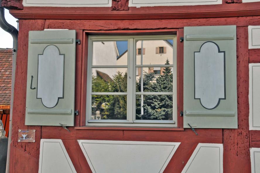 graues Holzfenster rotes Fachwerk Blendläden Denkmalschutz Sprossenfenster