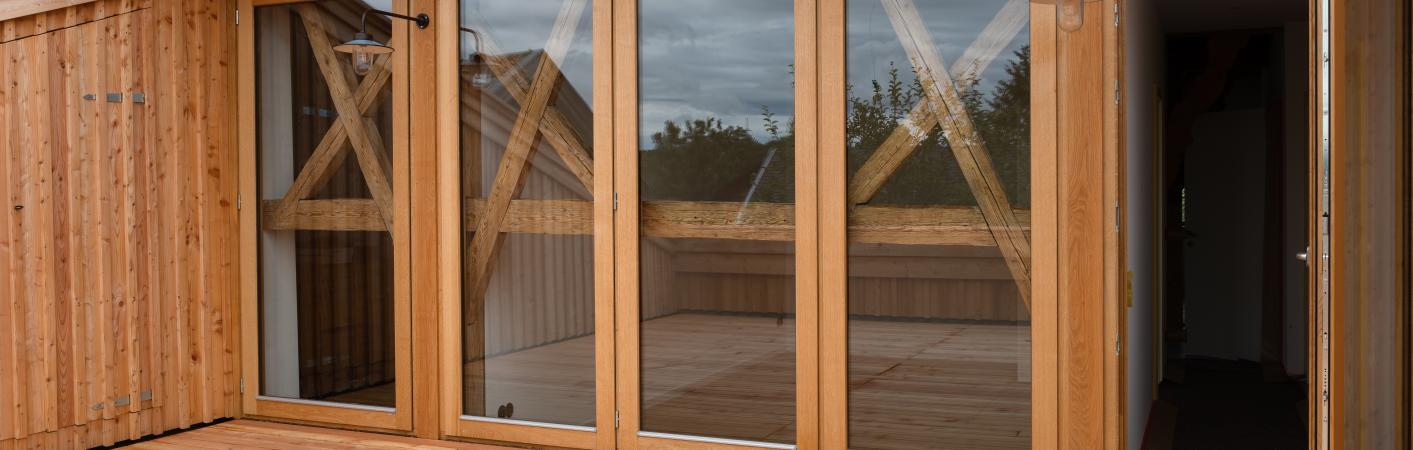 Bodentiefe Holz-Fenster auf Terrasse